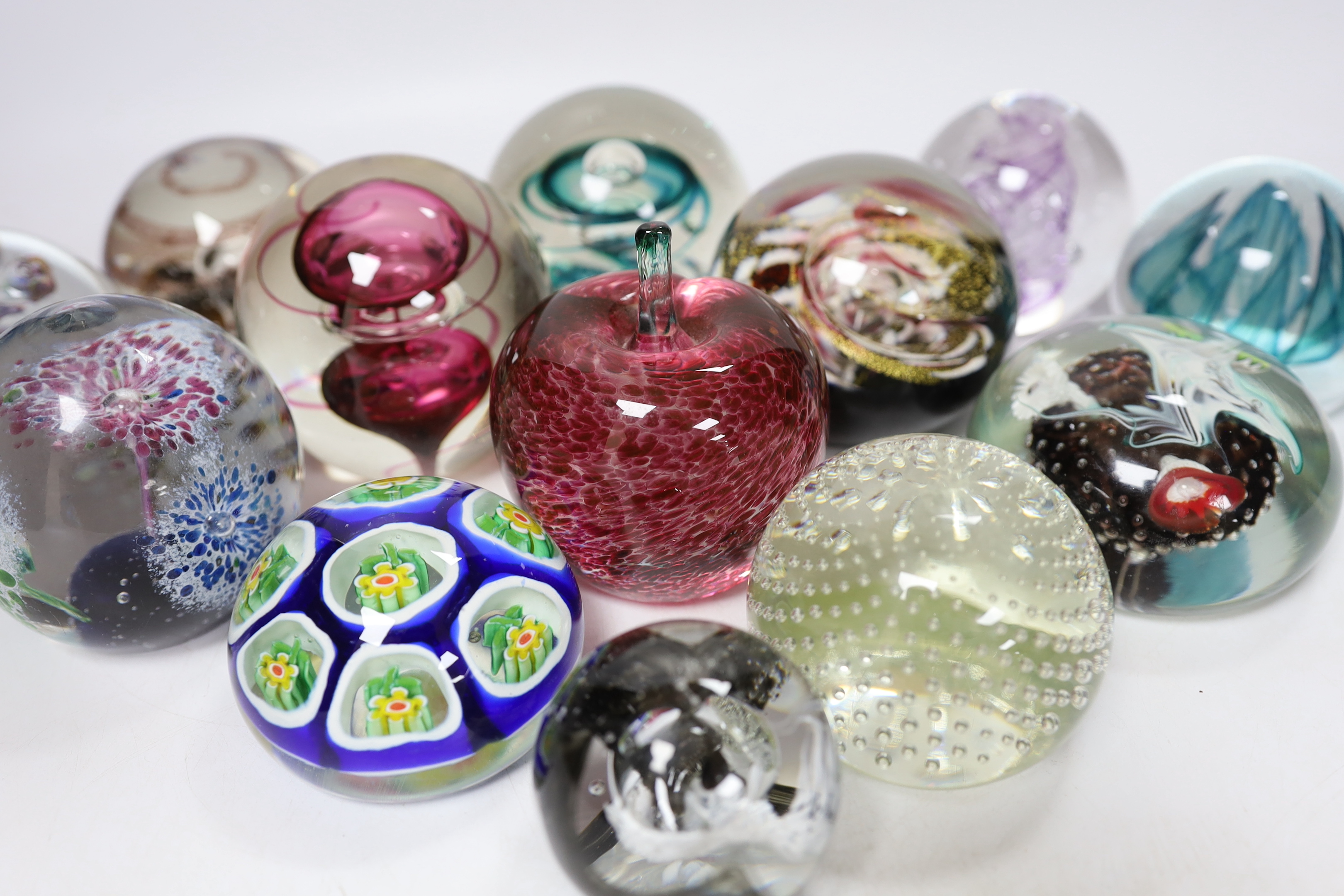 Thirteen glass paperweights including Caithness and Murano, largest 9cm in diameter